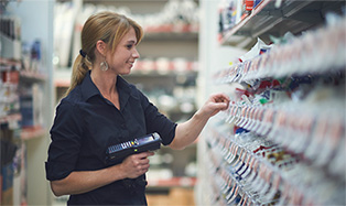 woman scanning bin tags in store